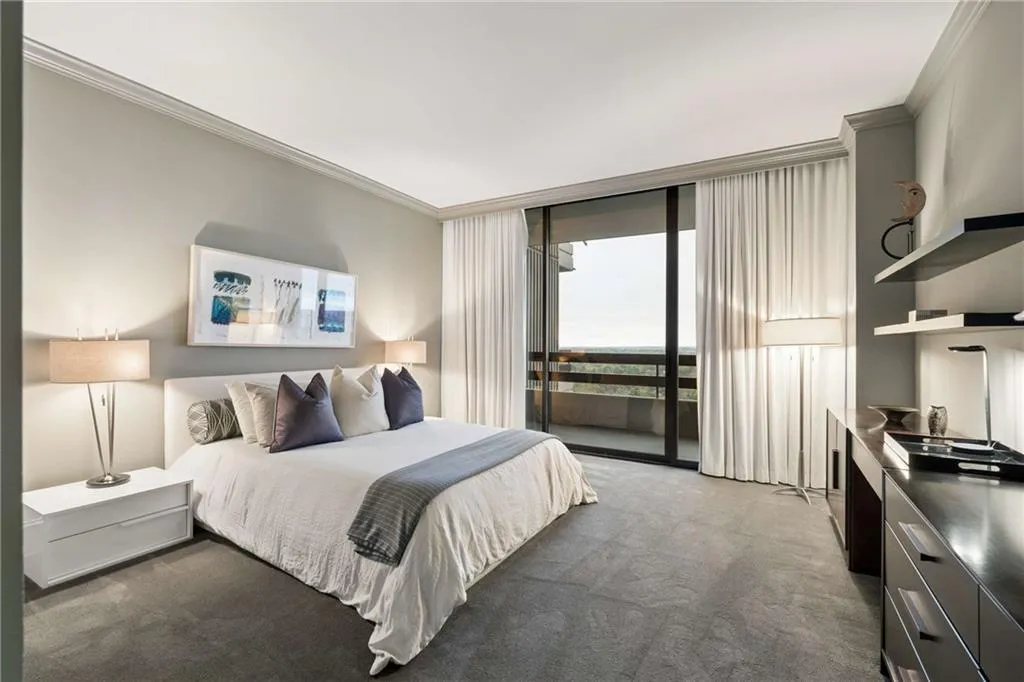 Bedroom featuring ornamental molding, dark colored carpet, access to outside, and floor to ceiling windows