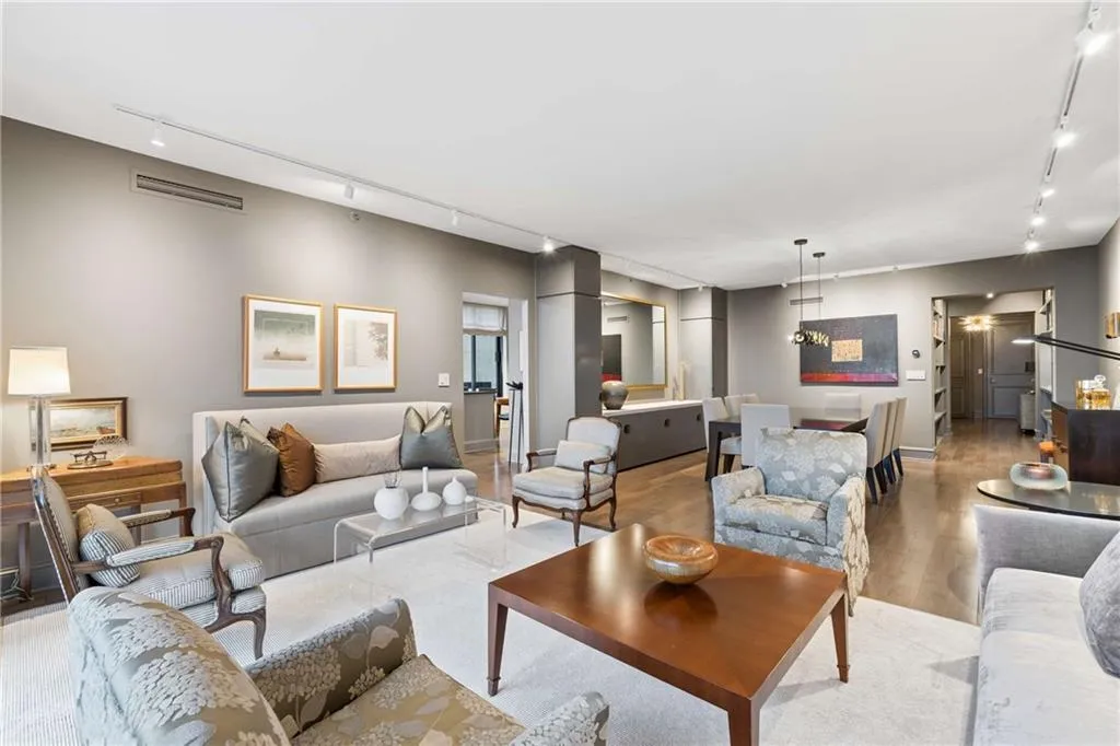 Living room featuring rail lighting and wood finished floors