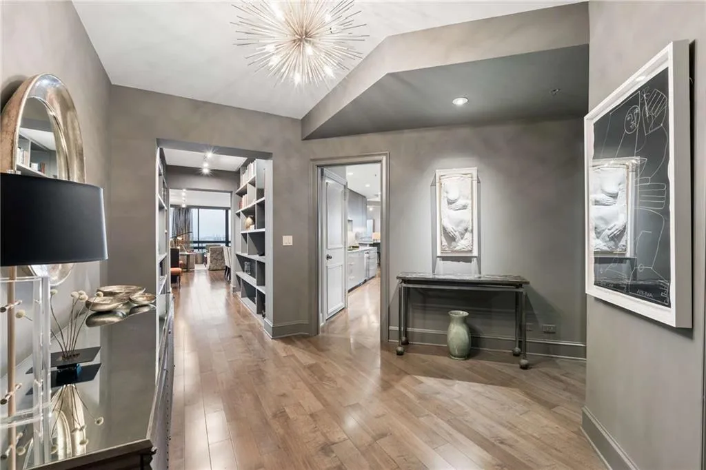Hallway featuring light wood-style floors and hanging lights
