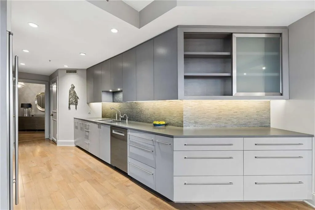 Kitchen with gray cabinets, light wood-style flooring, modern cabinets, recessed lighting, and dishwasher