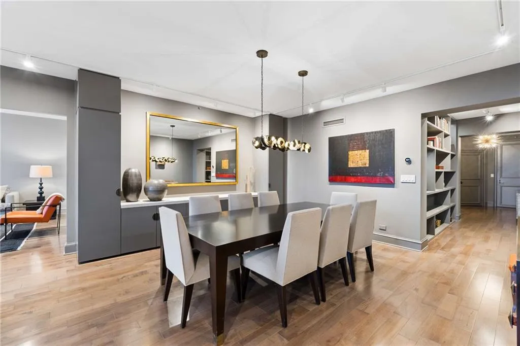 Dining room with rail lighting and light wood finished floors