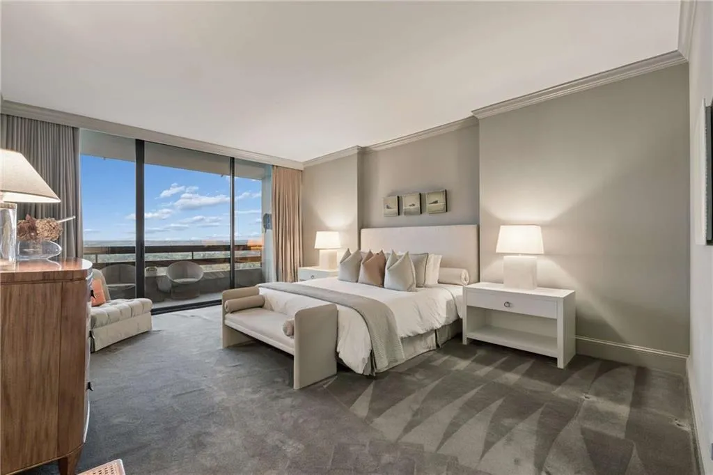 Bedroom with ornamental molding, access to exterior, floor to ceiling windows, and dark colored carpet