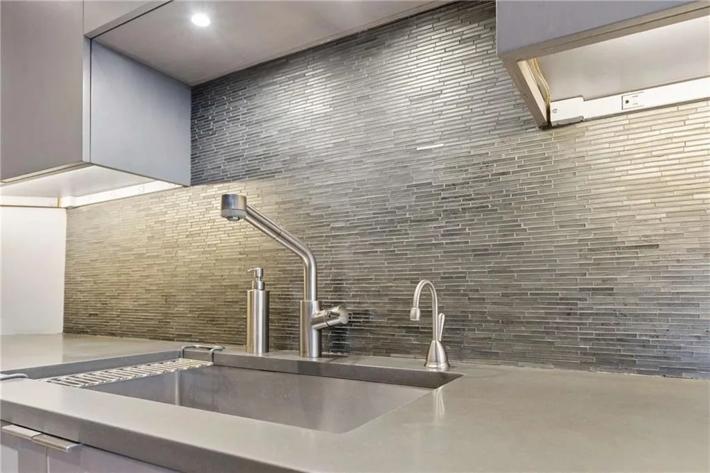 Kitchen view of decorative backsplash and light stone counters
