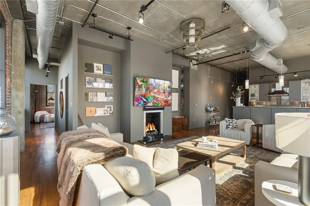 Living room featuring dark hardwood / wood-style flooring and a high ceiling