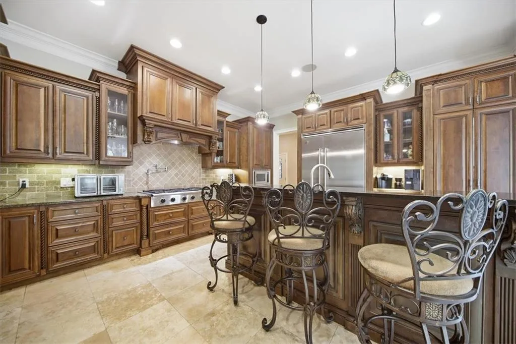 Kitchen with breakfast bar, walk-in Pantry, and Viking Refrigerator.