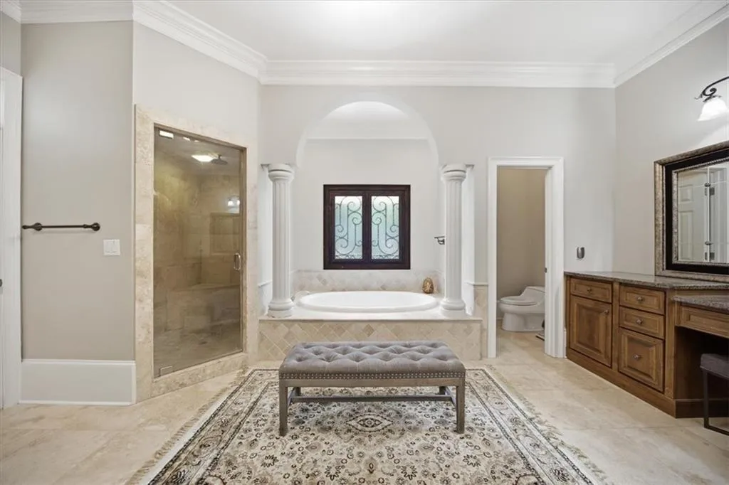 Primary Bathroom with Garden Tub, Steam Shower, and Dual Vanities.