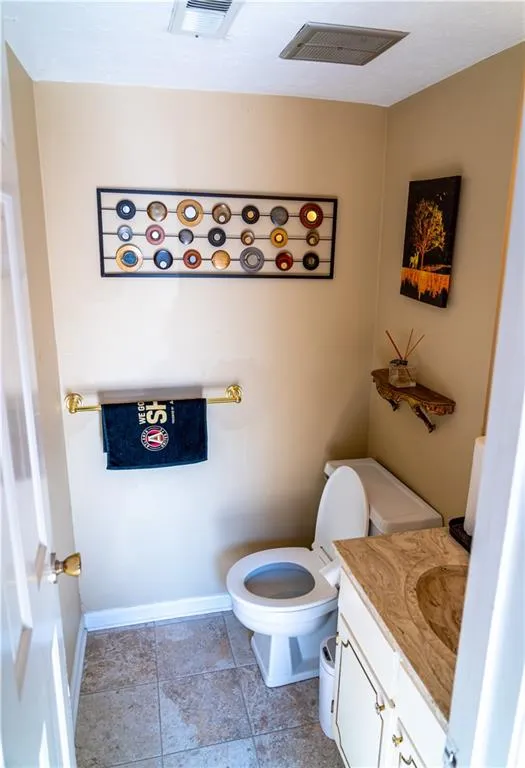 Half bathroom featuring toilet and vanity