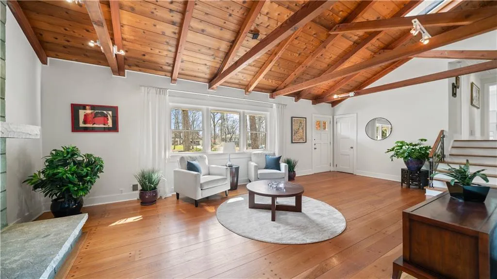 Living room with wood ceiling, light hardwood / wood-style flooring, beamed ceiling, and high vaulted ceiling