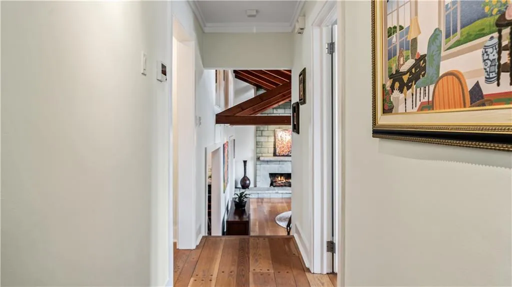 Corridor featuring crown molding and light wood-type flooring