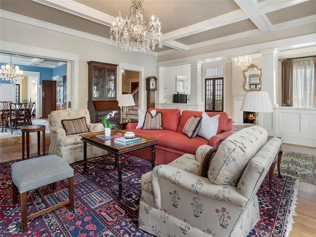 Living area featuring a chandelier, a wealth of natural light, and a lit fireplace