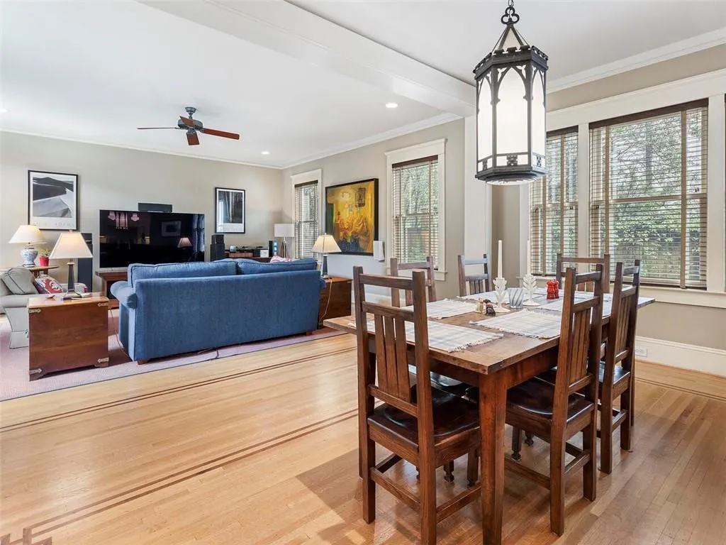 Dining area with a wealth of natural light, crown molding, and wood finished floors