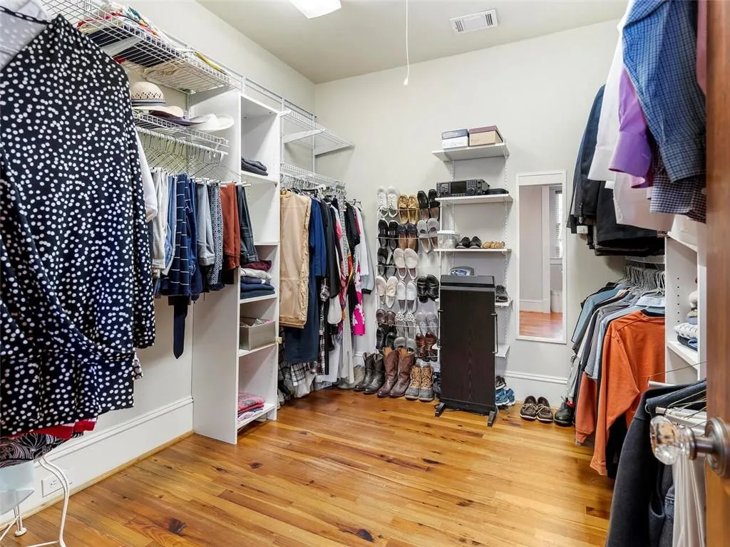 Walk in closet with light wood-style floors and visible vents