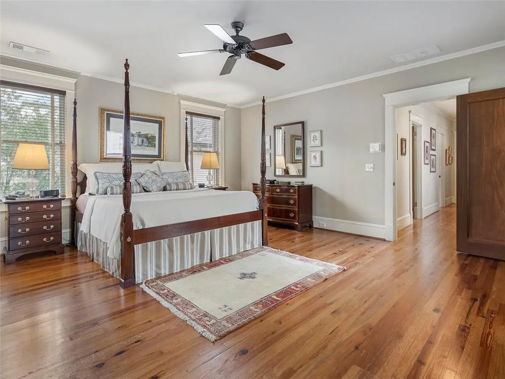 Bedroom with ornamental molding, light wood-type flooring, and visible vents