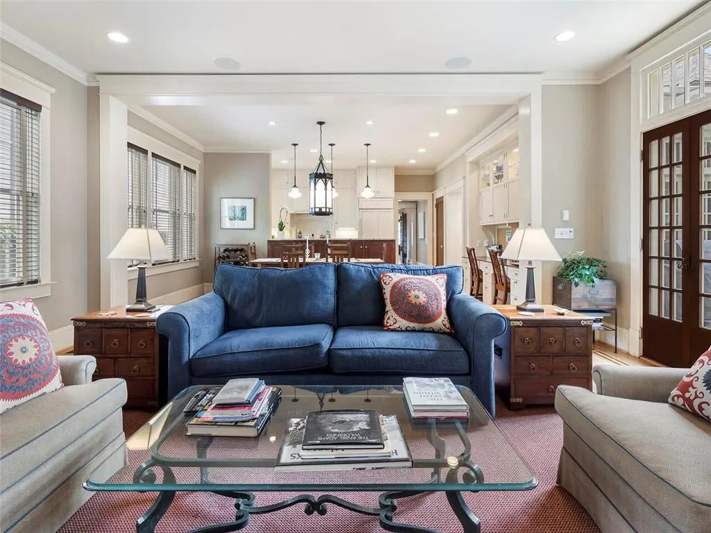 Living room featuring baseboards, crown molding, and recessed lighting
