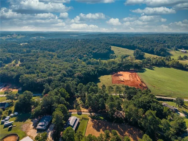 Expansive acreage featuring wooded areas, open fields, and cleared ground