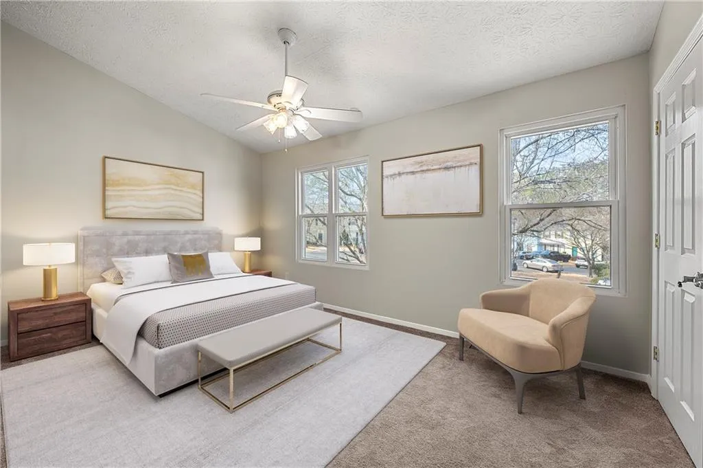 Carpeted bedroom with vaulted ceiling, multiple windows, a textured ceiling, and baseboards