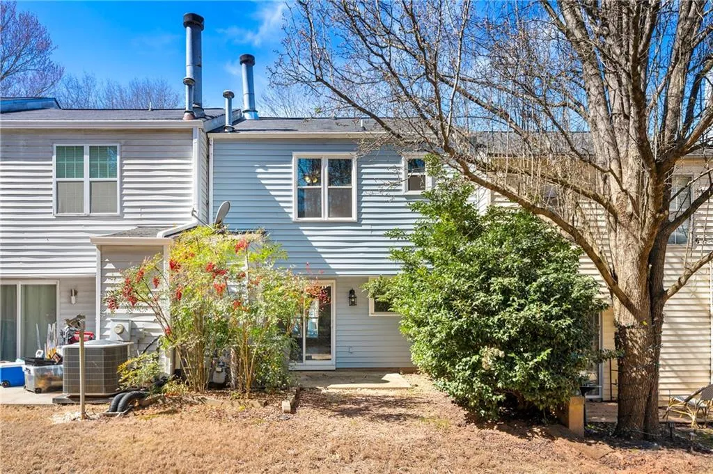 Back of house with central AC