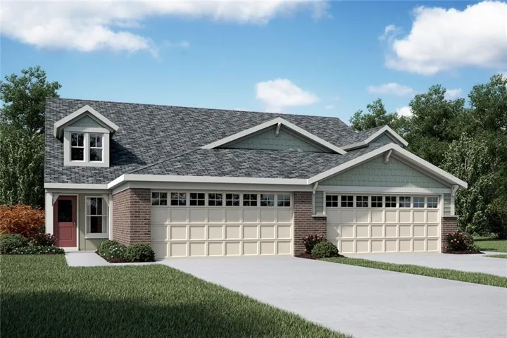 View of front of house with an attached garage, a front lawn, driveway, and brick siding
