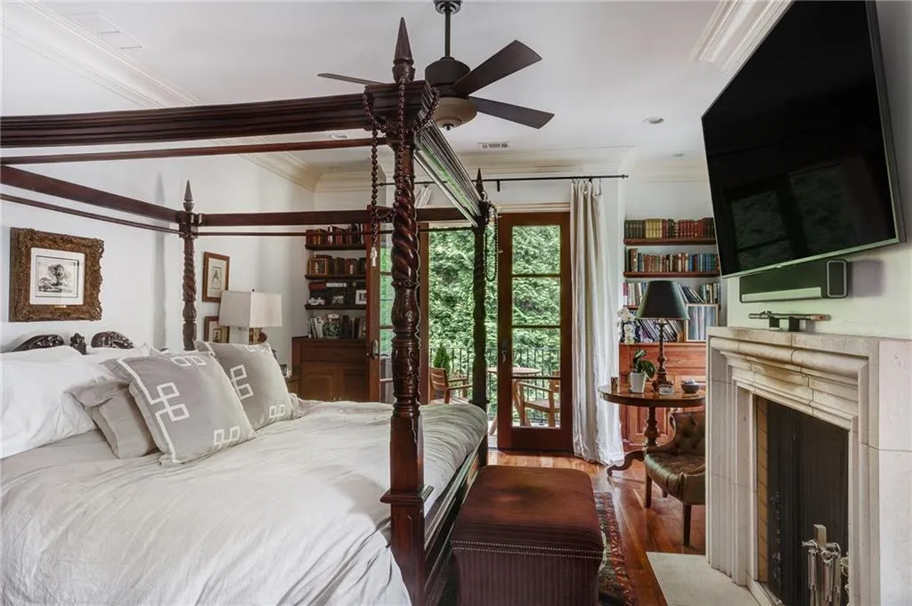 Primary bedroom with wood-type flooring, ceiling fan, crown molding, and access to exterior