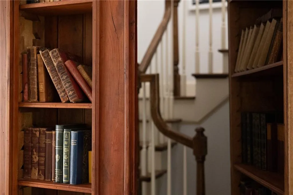 Secret door leads to top floor with oversized bedroom with two queen beds