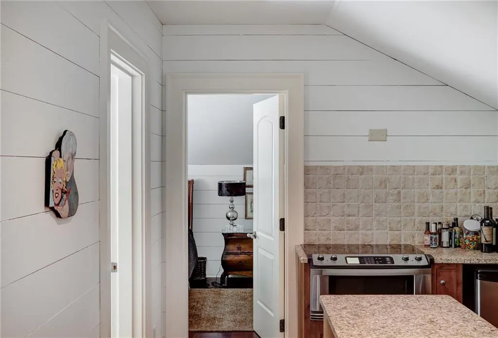 Garage apartment kitchen with vaulted ceiling and appliances with stainless steel finishes