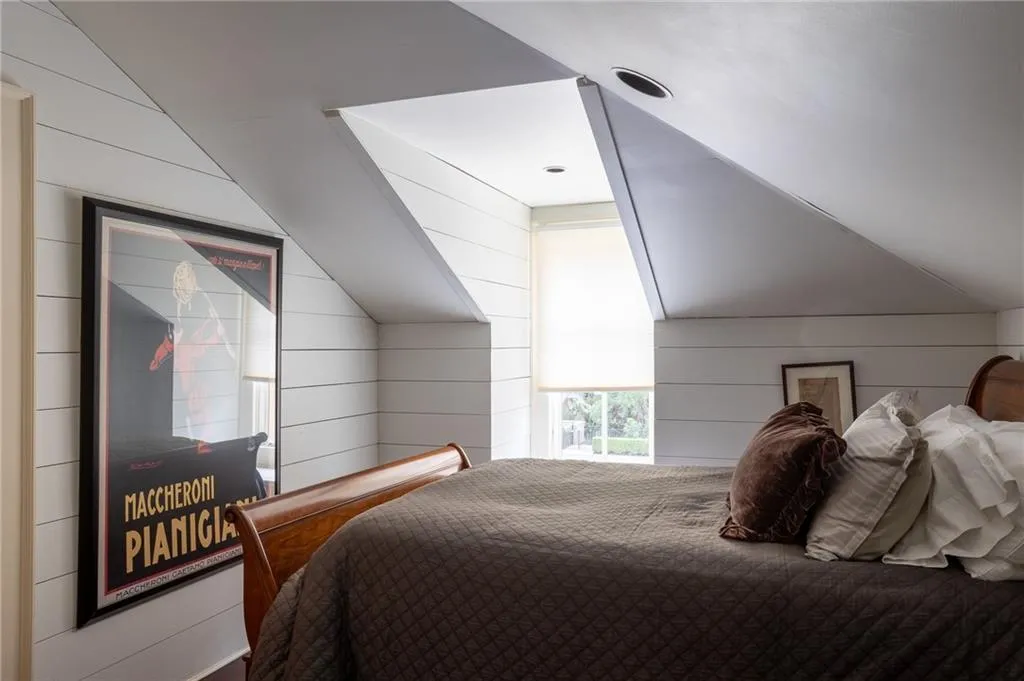 Garage apartment bedroom featuring vaulted ceiling