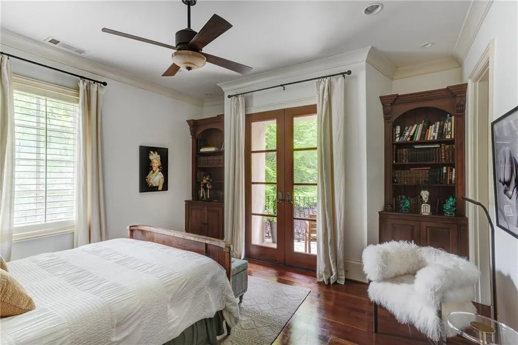 Guest bedroom two with french doors dark hardwood / wood-style floors, and access to exterior