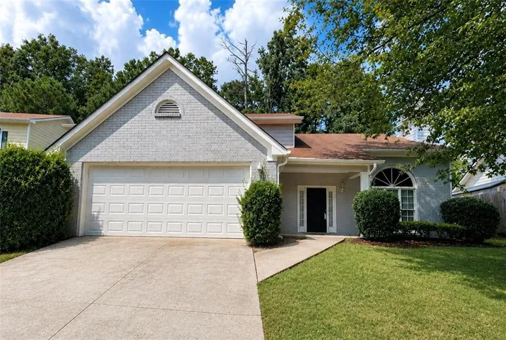 Traditional exterior with light gray brick and siding accents