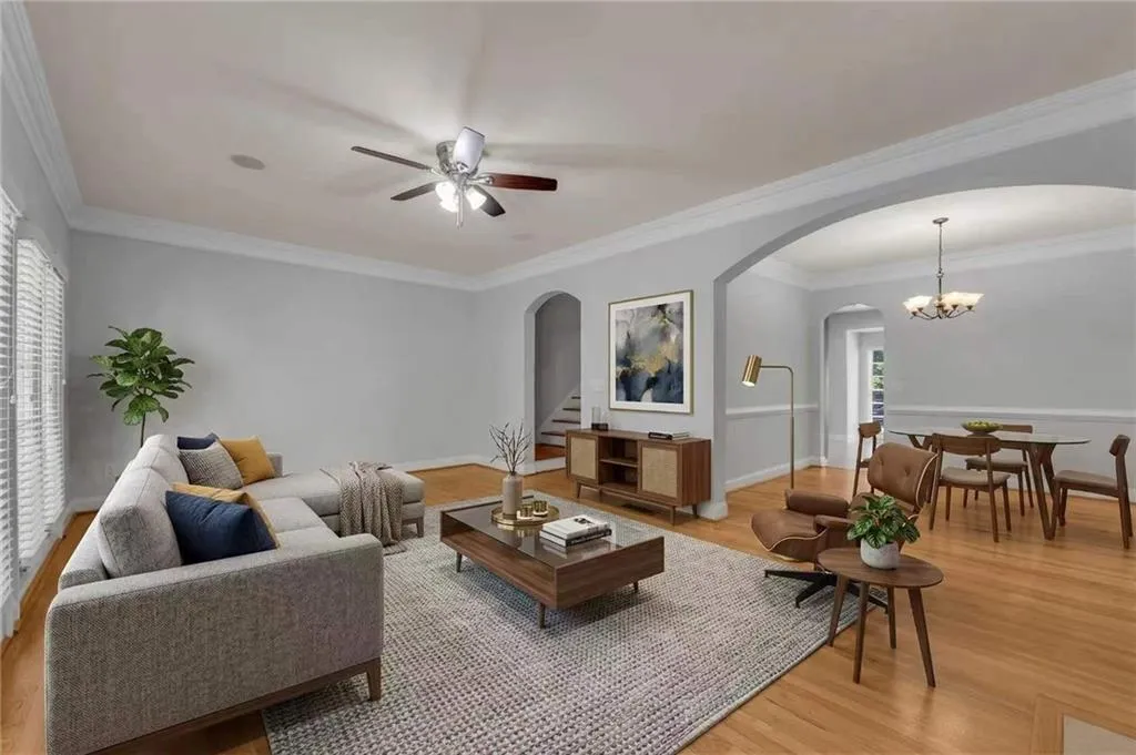 Hardwood flooring, crown molding, arched entryways, and ceiling fan