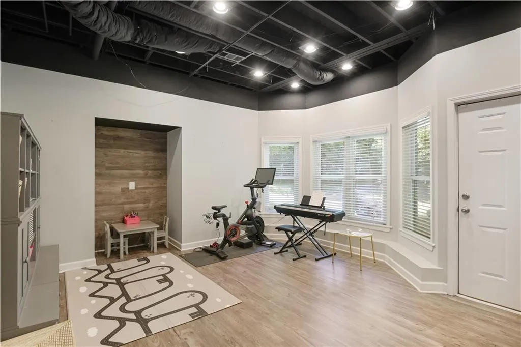 Exercise area with light hardwood / wood-style flooring