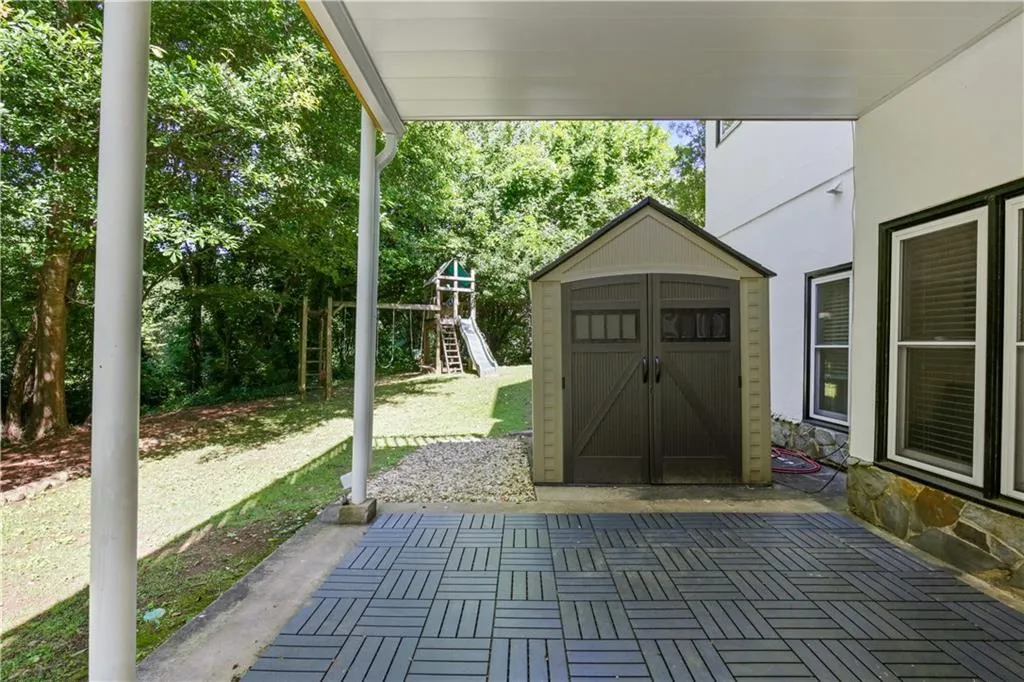 View of terrace with a playground and a storage unit