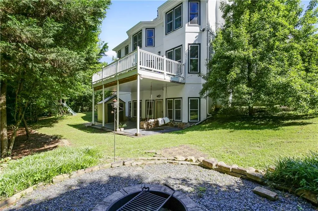 Back of property featuring a patio and a yard