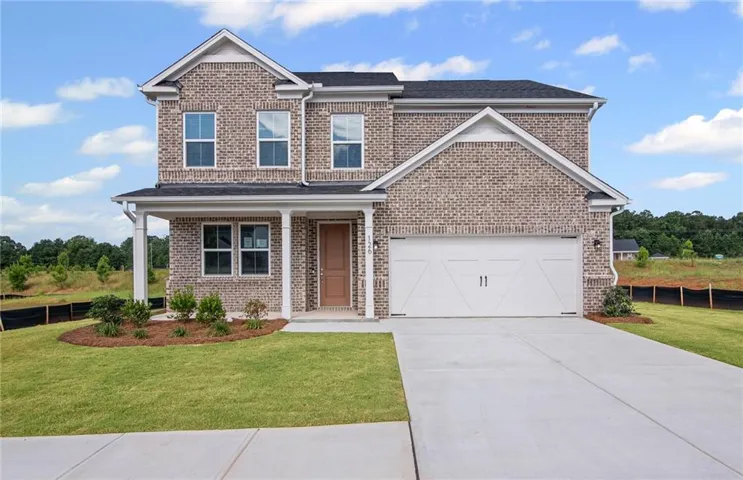 **Photos are not of actual home.** Traditional home with brick siding, covered porch, driveway, and a front lawn