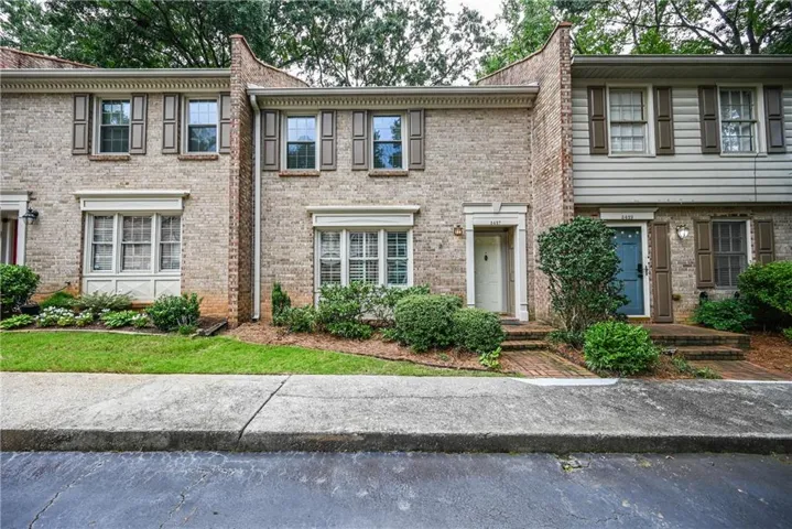 Brick exterior with multiple windows and decorative shutters