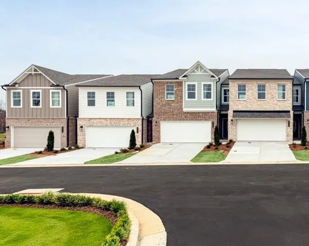 Craftsman-style home with an attached garage, a residential view, and concrete driveway