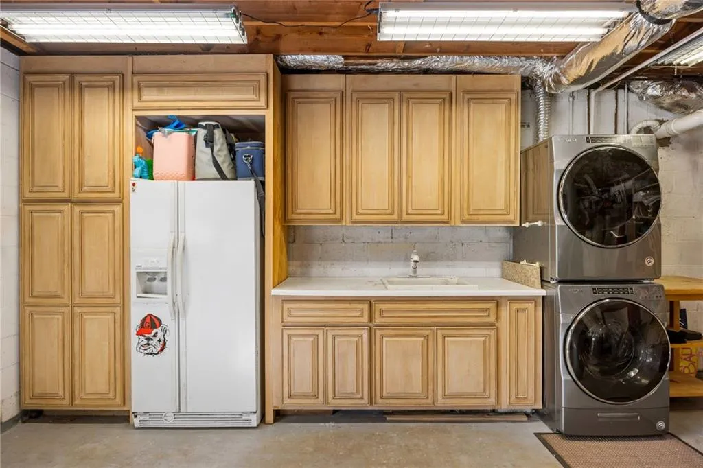 Secondary Laundry with Utility sink in Garage Space-Lots of custom cabinets! Additional Storage room is HUGE in basement!