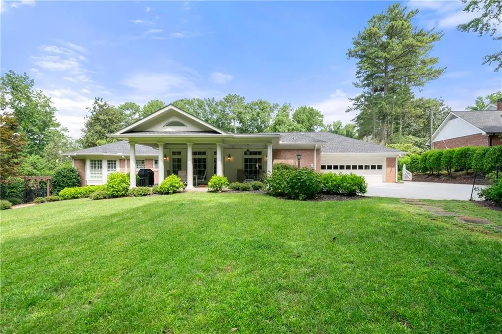 View of rear of home with a garage and a front lawn