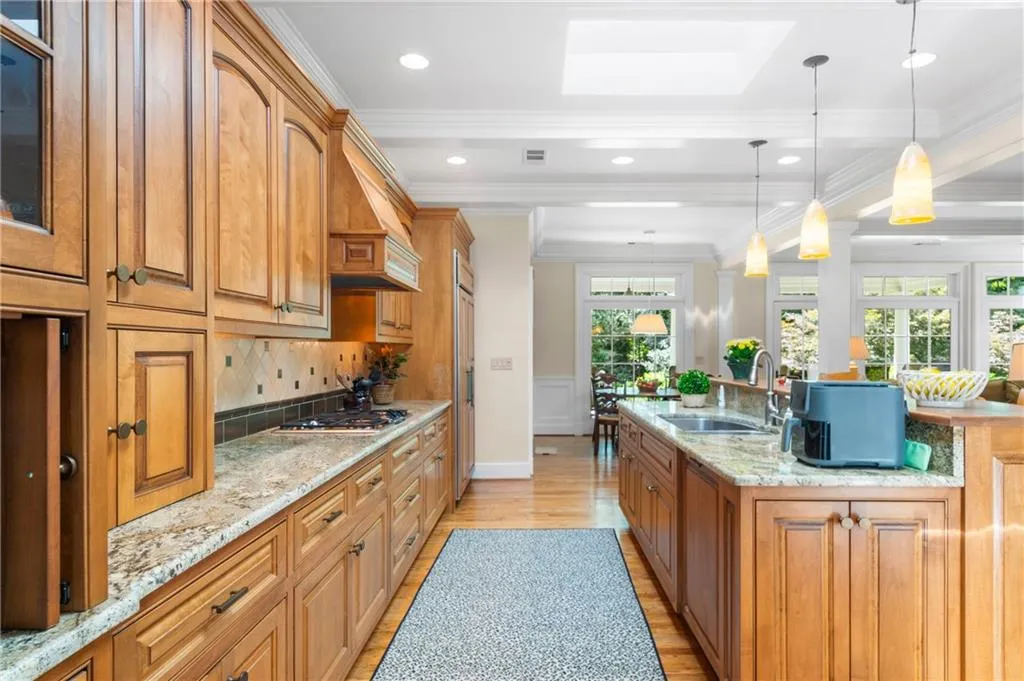 Kitchen featuring light stone countertops, light wood-type flooring, and plenty of natural light