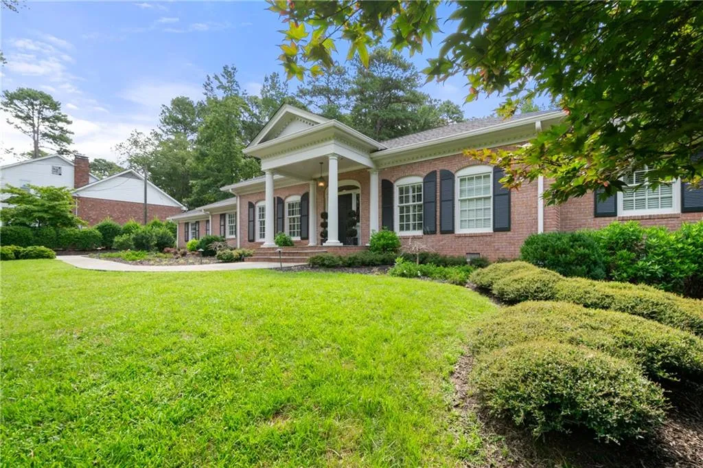 View of front of property with a level large front lawn