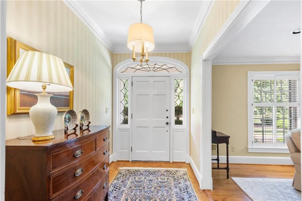 Entrance foyer featuring ornamental molding, and a wealth of natural light