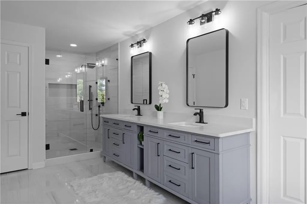 Bathroom featuring vanity and a shower with door