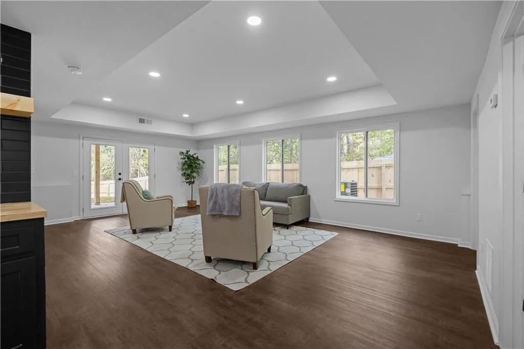 Living room featuring hardwood / wood-style floors, french doors, and a raised ceiling