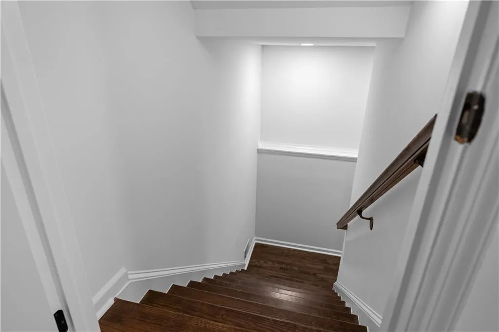 Stairway featuring hardwood / wood-style floors