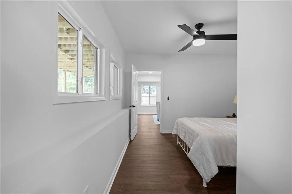 Bedroom with ceiling fan and dark hardwood / wood-style floors