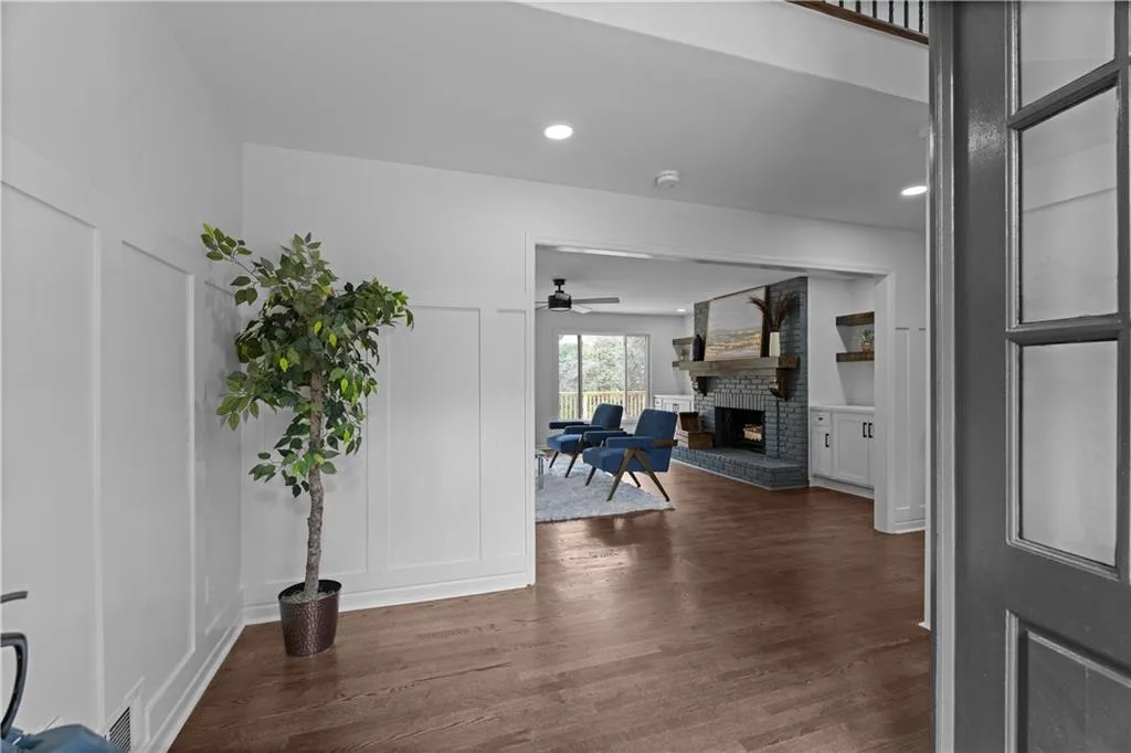 Corridor with dark hardwood / wood-style flooring