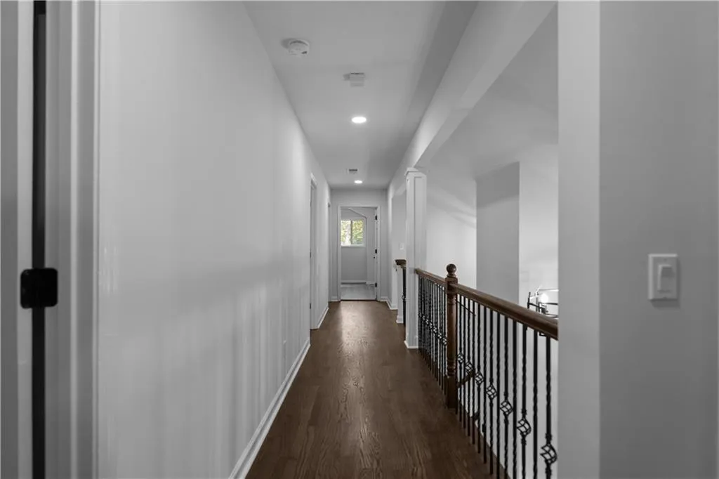 Corridor with dark hardwood / wood-style floors