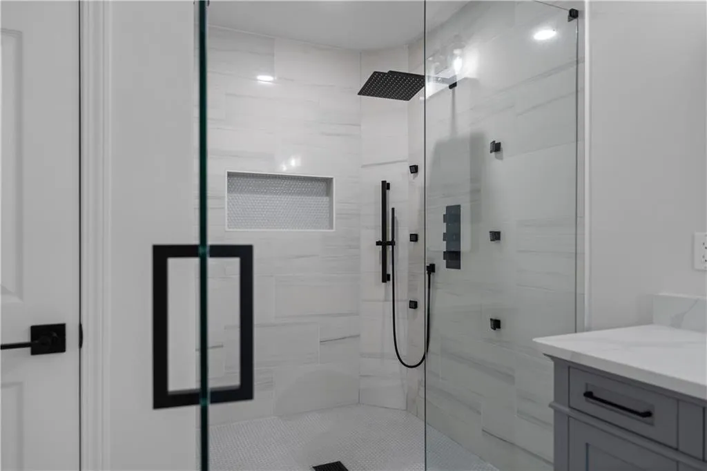 Bathroom featuring vanity and a shower with door