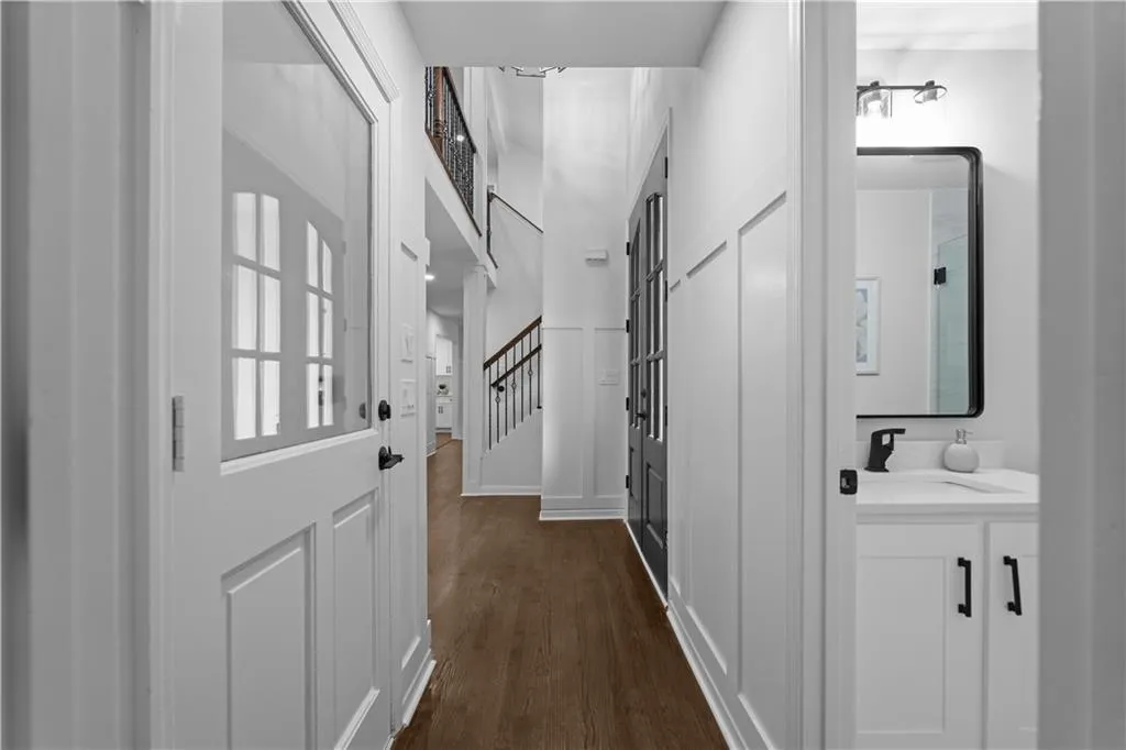 Hall with dark hardwood / wood-style floors and sink