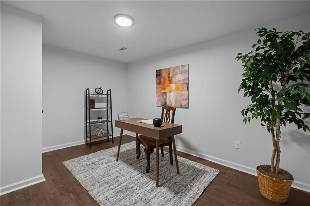 Office area featuring dark wood-type flooring