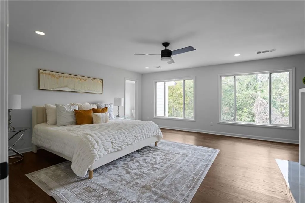 Bedroom with ceiling fan and dark hardwood / wood-style floors
